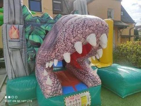 Hüpfburg mieten Dino World T-Rex mit Rutsche – Profi Springburg 4x4x4 m inkl. Zubehör – 2