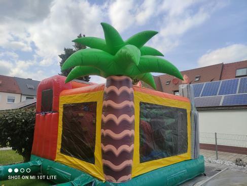 Hüpfburg mieten Dino World T-Rex mit Rutsche – Profi Springburg 4x4x4 m inkl. Zubehör – 4