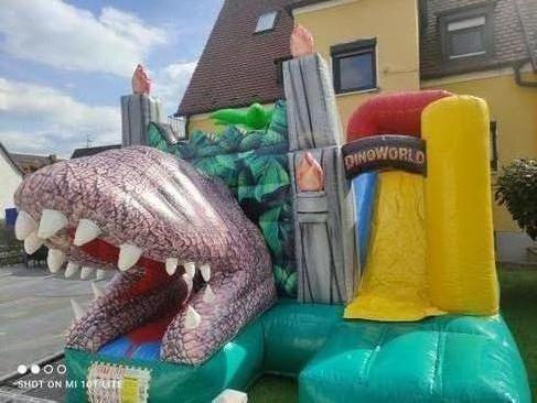 Hüpfburg mieten Dino World T-Rex mit Rutsche – Profi Springburg 4x4x4 m inkl. Zubehör